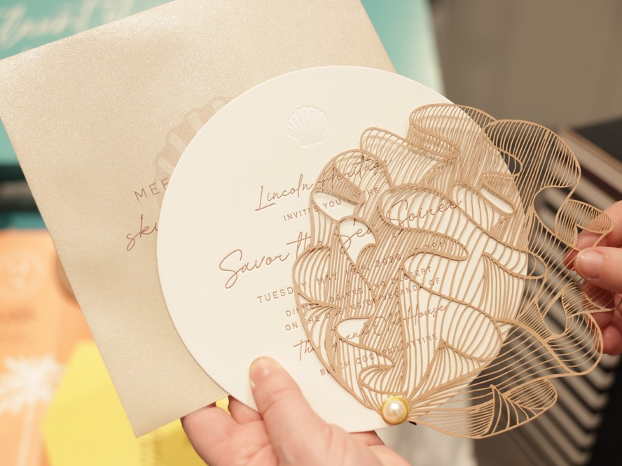 A laser-cut coral invitation to an incentive program's closing gala, paired with a shimmering gold envelope.